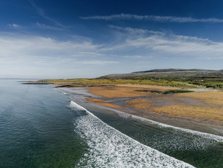 West coast of Ireland, Fanore beach, Clare county, Sandy beach, blue sky and water. Aerial drone view.