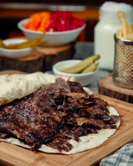 Overroasted meat slices in tortilla