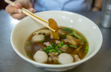 Eating clear stewed beef soup in Thailand, focus selective.