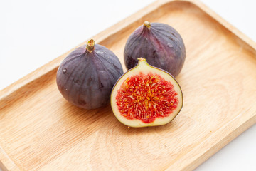 sliced juicy figs on a wooden plate