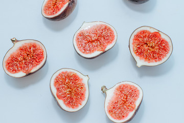 sliced juicy figs on a blue background. top view