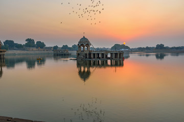 Gadisar lake in the morning at sunrise. Man-made water reservoir with temples in Jaisalmer. India