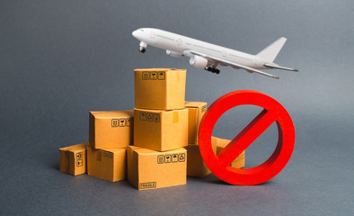 Cargo plane, many boxes and red prohibition symbol NO. Embargo trade wars. Restriction on importation, ban transit export dual-use goods to countries under sanctions. transport companies. - obrazy, fototapety, plakaty