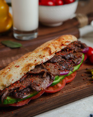 Meat slices in bread with cucumber and tomato
