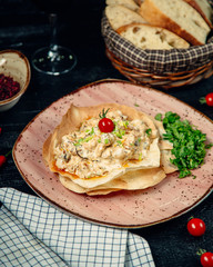 Tortilla filled creamy salad and topped with herbs