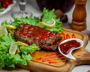 Meat steak served with ketchup