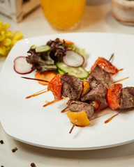 Fried meat and vegetables on stick