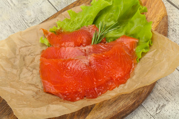 Sliced salmon fillet served rosemary