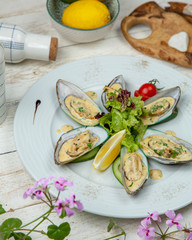 Oysters in cheese sauce with herbs