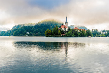 View at the Church of Assumption of St.Mary in morning haze at the Island of Bled Lake in Slovenia