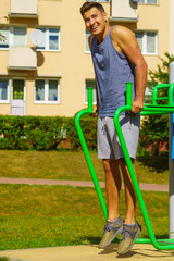 Man doing sit ups in outdoor gym