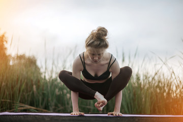 Girl practice yoga early morning on pier