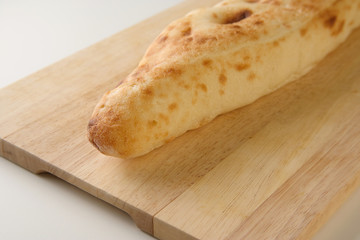 Diagonal view of Georgian traditional freshly baked bread shoti on wooden board