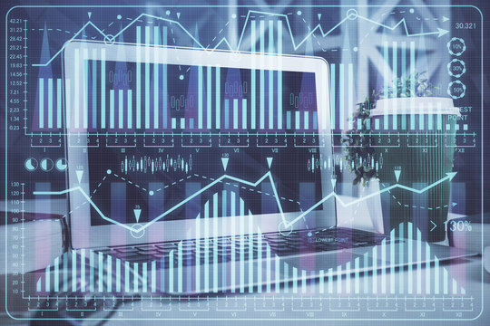 Financial graph colorful drawing and table with computer on background. Double exposure. Concept of international markets.