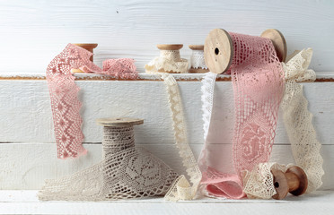 Handmade linen laces trims on wooden spools.
