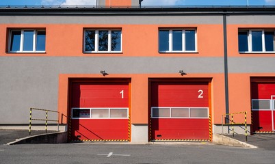Doors of a fire station with numbers and trucks