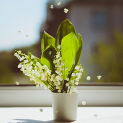 Lily of the valley in a vase with flying inflorescences