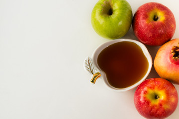 Fruits and honey health background. Apple, pomegranate and honey, traditional food of Jewish New Year - Rosh Hashana. Copy space background. Healthy food concept.Top view.