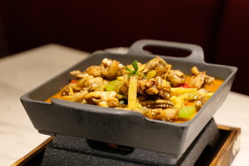 close up tasty Bullfrog Hotpot on restaurant table under light, Blur background. Popular Chinese...