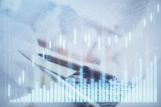 Financial graph colorful drawing and table with computer on background. Multi exposure. Concept of international markets.