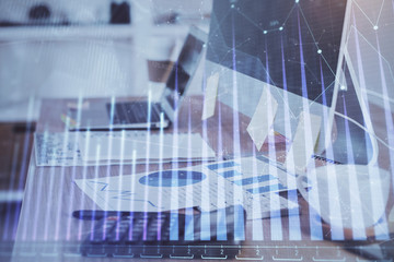 Financial market graph hologram and personal computer on background. Double exposure. Concept of forex.