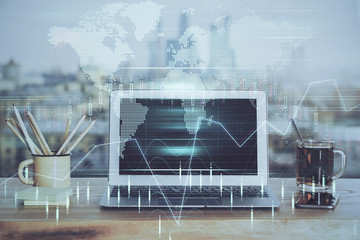 Double exposure of chart and financial info and work space with computer background. Concept of...