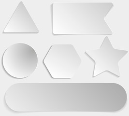 Set of white paper stickers of different shapes on gray gradient background. Round, square, hexagonal, star, triangular.