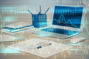 Financial graph colorful drawing and table with computer on background. Double exposure. Concept of international markets.