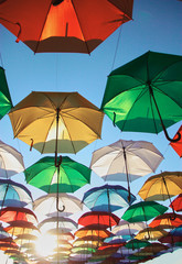 Fototapeta na wymiar many colorful sunny umbrellas decorate the street