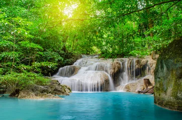 Foto op Plexiglas Deep forest waterfall at Erawan waterfall, beautiful waterfall with sunlight rays in deep forest, Erawan National Park in Kanchanaburi, Thailand © TeTe Song
