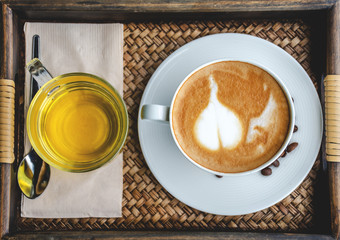 Coffee and tea in the cup on wooden table in cafe. Selective focus.