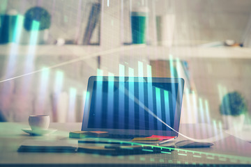 Stock market graph and table with computer background. Double exposure. Concept of financial analysis.