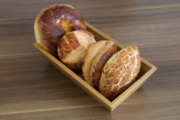 Turkish pastry products are Pogaca, Simit at patisserie on the wooden background.