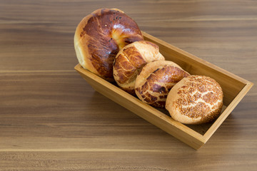 Turkish pastry products are Pogaca, Simit at patisserie on the wooden background.