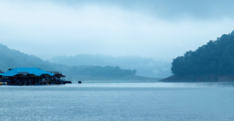 Mountains, hut, lakes and the early morning fog