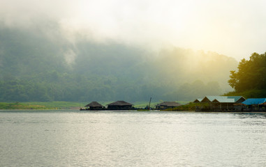 Mountains, hut, lakes and the early morning fog
