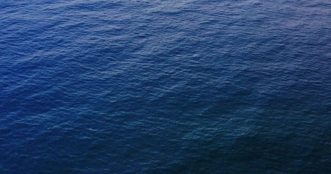 Aerial view of deep blue ocean water texture, movement of the ocean background