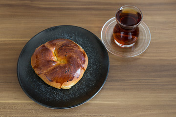 Turkish pastry products are Pogaca, Simit at patisserie on the wooden background.