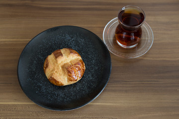 Turkish pastry products are Pogaca, Simit at patisserie on the wooden background.