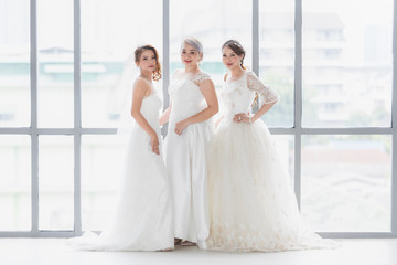 Group of beautiful Asian brides stand and poses..