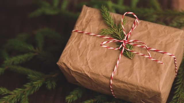 Christmas gifts box presents on brown wooden background. wrapping christmas present in craft paper.