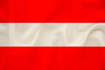 national flag of Austria on delicate silk with wind folds, travel concept, immigration, politics