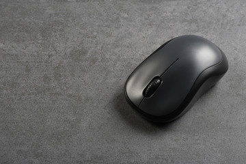 Computer mouse on the gray stone texture with copy space