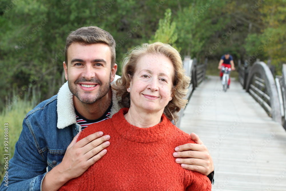 Wall mural Mother and son smiling outdoors 