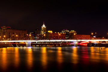 Fototapeta na wymiar Krasnopresnenskaya embankment and Novoarbatskiy bridge. Cityscape of night Moscow.