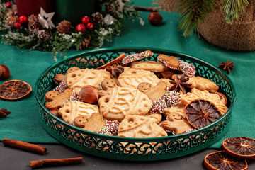 Tasty homemade Christmas cookies in the green plate.