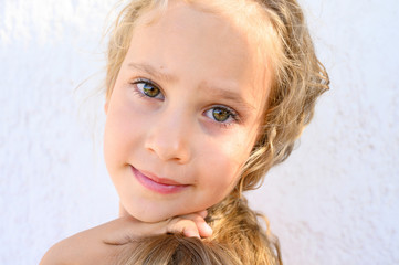 Portrait of a cute little child girl with curly hair