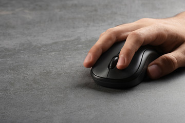 A male finger pushing computer mouse push button with copy space