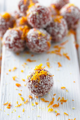 Homemade natural candy made from nuts, fruit dates, orange, and coconut. Healthy vegan food.