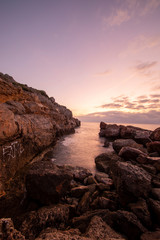 Fototapeta na wymiar Sunrise between rocks and the Oropesa Sea